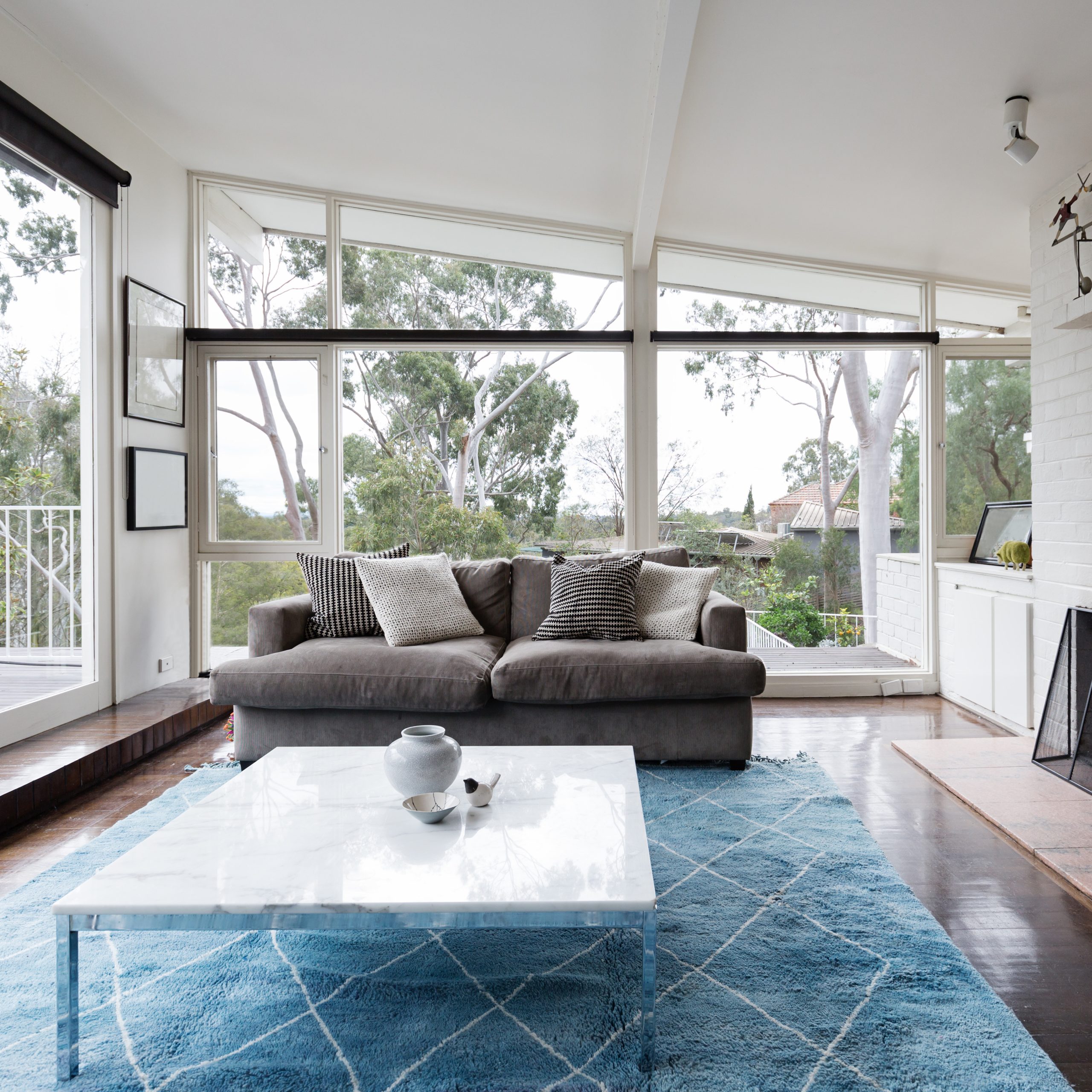 Mid century modern living room with huge windows to view the tre